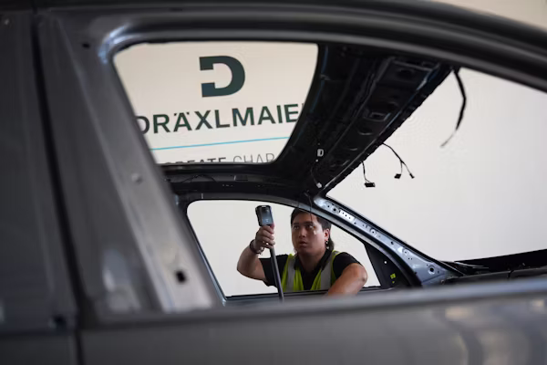 Mechanic performing pre-purchase car inspection Denver under the hood of a used car