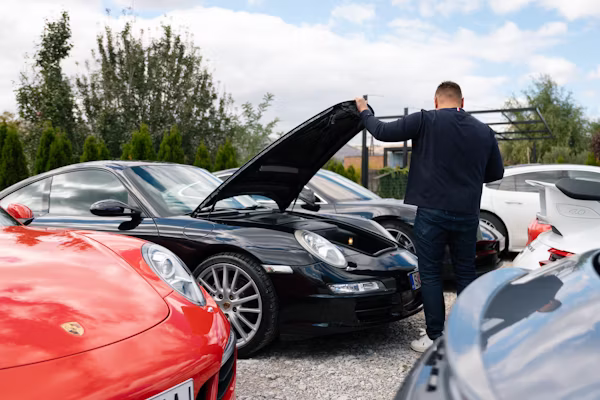 Mechanic inspecting the underside of a car during vehicle inspection Denver CO